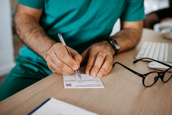 Healthcare workers vaccine mandate. A healthcare worker fills out a vaccination card.